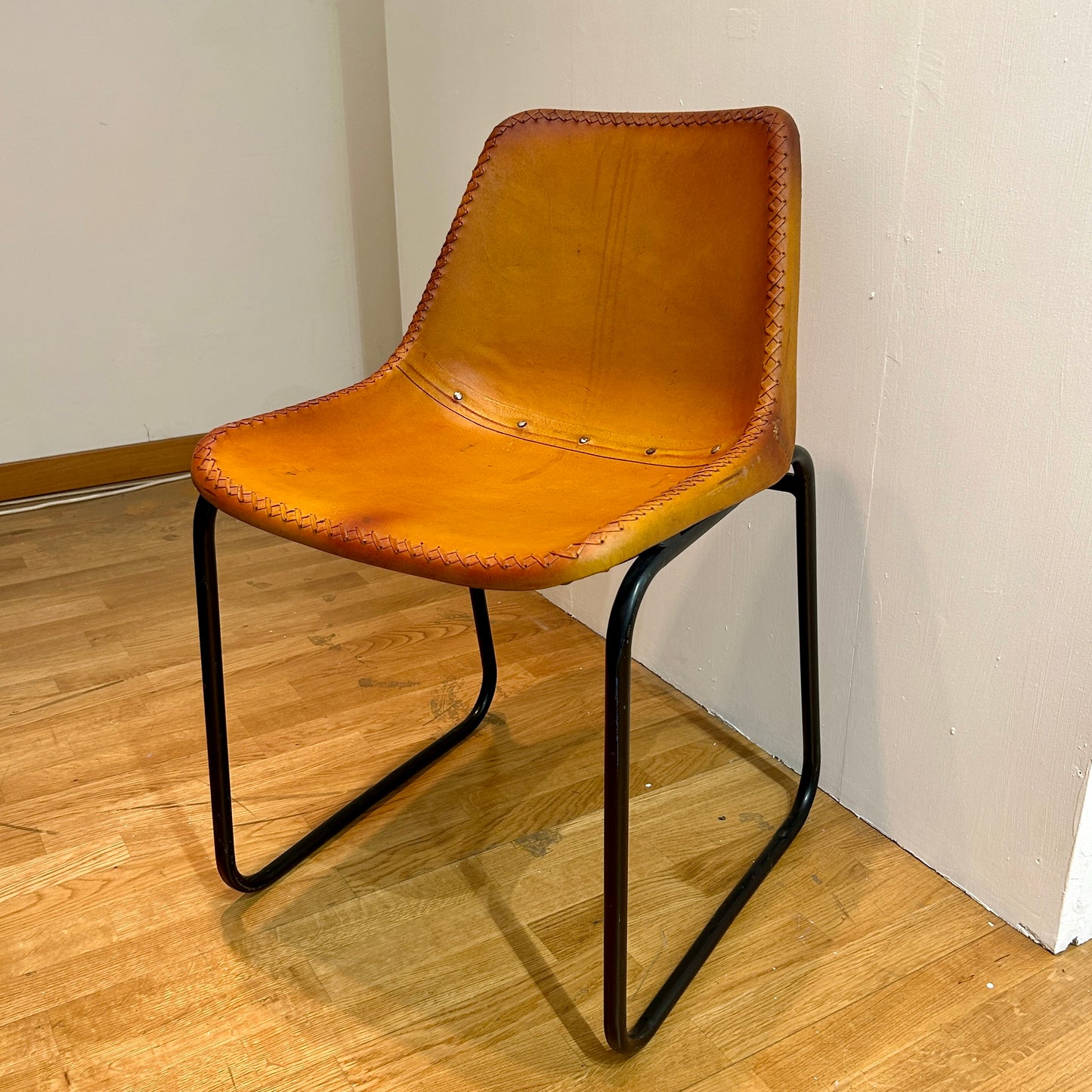 Leather covered chairs with braided edge detail