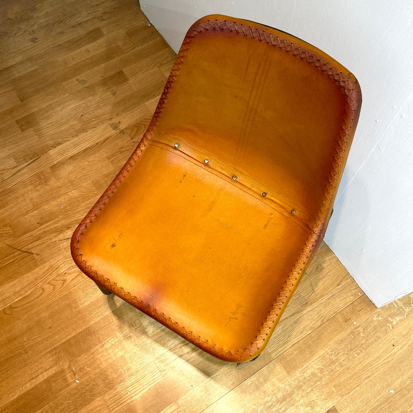 Leather covered chairs with braided edge detail